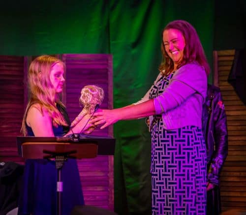 Haunted Doll Winner Jessi Waugh accepts her award from actress Kennedy Brooks